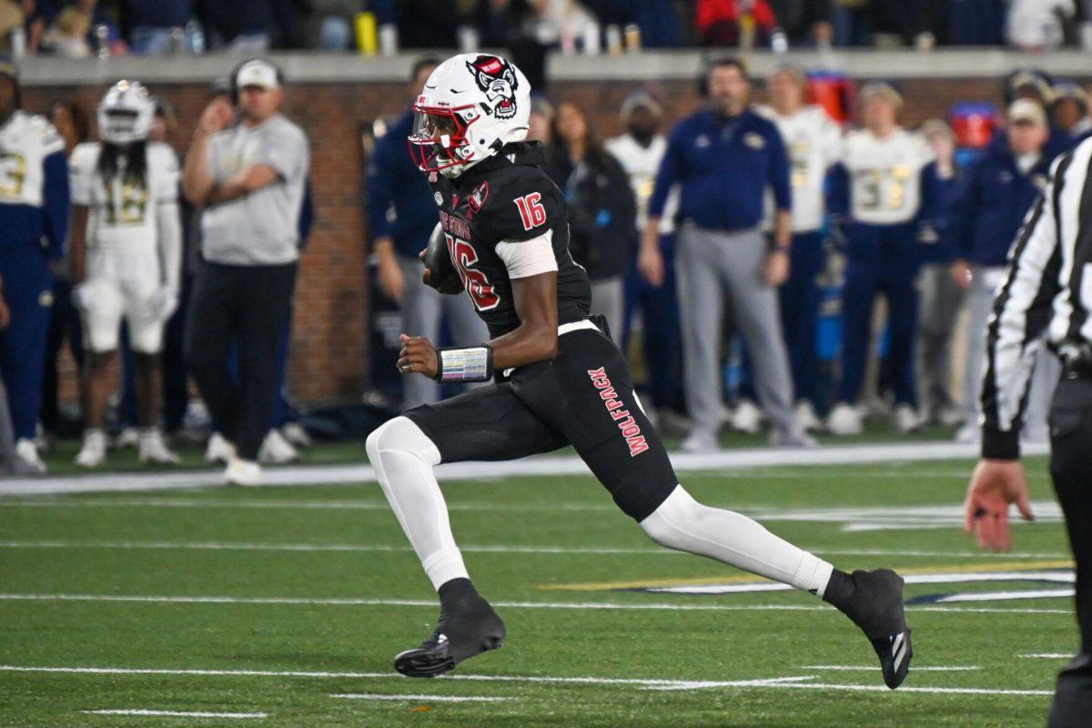 Freshman quarterback CJ Bailey rushes towards the end zone for a touchdown during the game against Georgia Tech in Bobby Dodd Stadium at Hundai Field in Atlanta on Thursday, Nov. 21, 2024. Bailey rushed for three touchdowns and threw three interceptions. NC State lost to Georgia Tech 30-29.