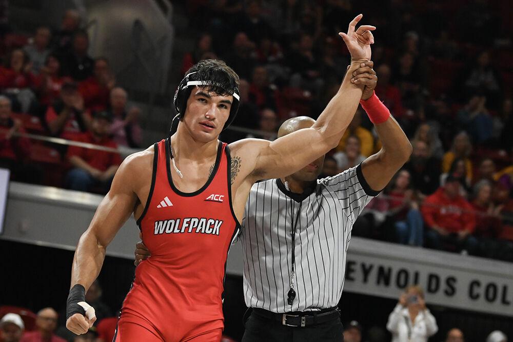 Redshirt sophmore Matty Singleton celebrates his win during the duel against Appalachian State in Reynolds Coliseum on Friday, Nov. 15, 2024. Singleton won the 197 bout 9-2. NC State beat App State 34-12.