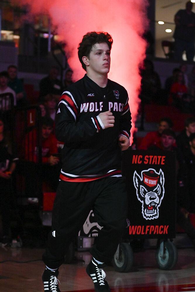 Redshirt freshman Koy Buesgens makes an entrance before the duel against Appalachian State in Reynolds Coliseum on Friday, Nov. 15, 2024. Buesgens won the 149 bout 7-5. NC State beat App State 34-12.