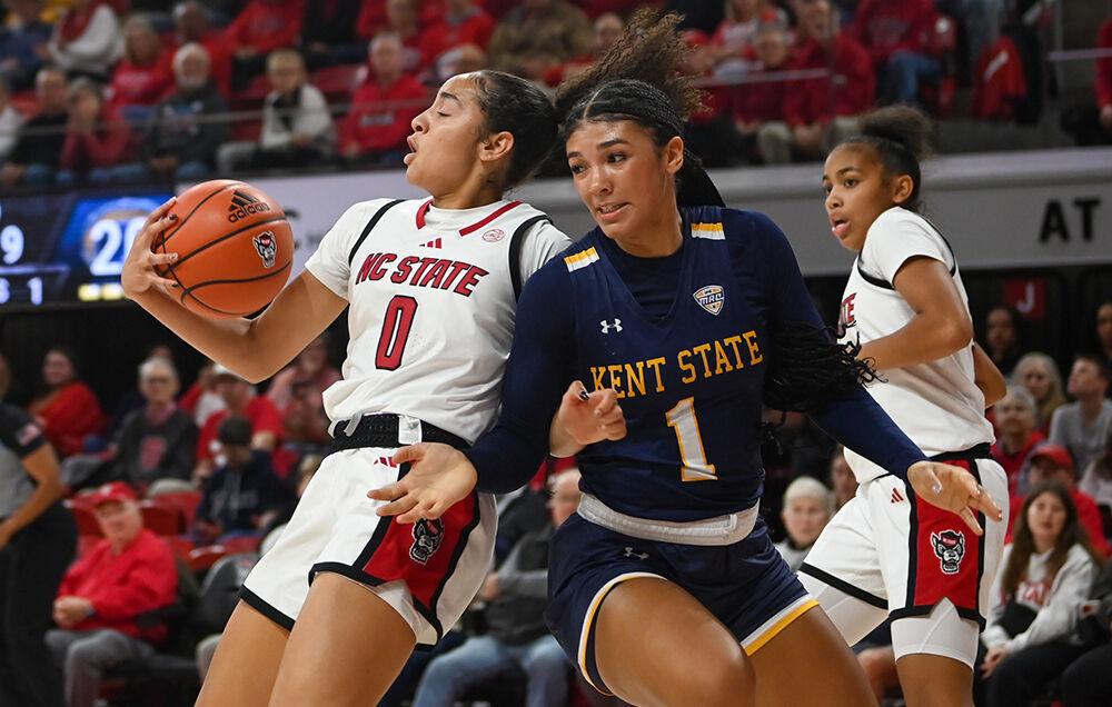 Freshman guard Devyn Quigley shields the ball from a defender during the game against Kent State in Reynolds Coliseum on Thursday, Nov. 14, 2024. Quigley had three assists. The Wolfpack defeated Kent State 79-51.