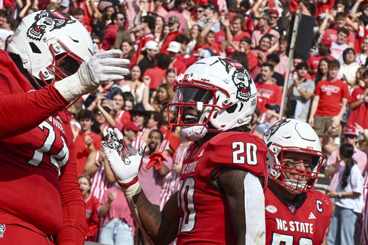 Graduate offensive tackle Anthony Belton, Redshirt Freshman running back Hollywood Smothers, and graduate offensive lineman Zeke Correll celebrate a touchdown during the game against Stanford at Carter-Finley Stadium on Saturday, Nov. 2, 2024. Hollywood scored two rushing touchdowns during the game. State beat Stanford 59-28.