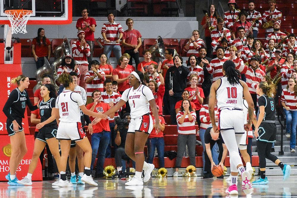 Graduate guard Madison Hayes, freshman center Lorena Awou and senior guard Aziaha James celebrate after scoring during the game against Coastal Carolina in Reynolds Coliseum on Thursday, Nov. 21, 2024. The Wolfpack beat the Chanticleers 89-68.