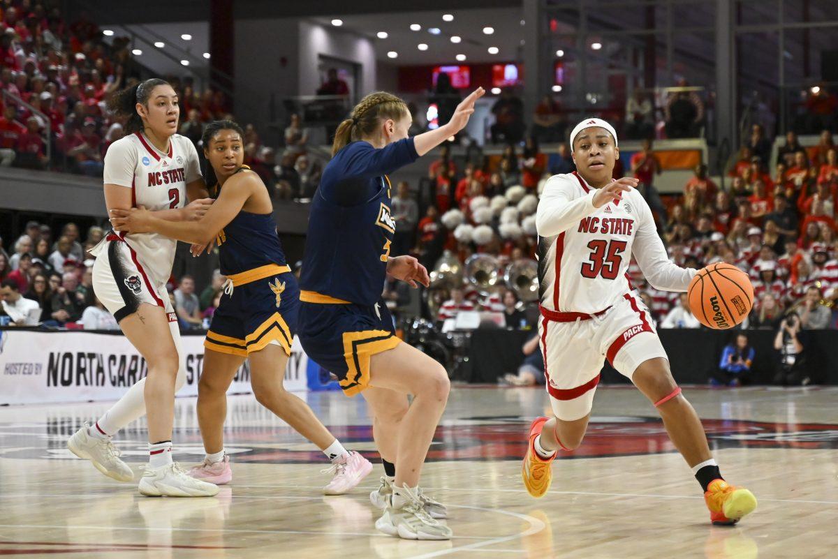 Freshman guard Zoe Brooks drives past the opposing team during the first round game of the NCAA tournament against Chattanooga at Reynolds Coliseum on Saturday, March 23, 2024. Brooks scored 4 points. NC State beat Chattanooga 64-45.