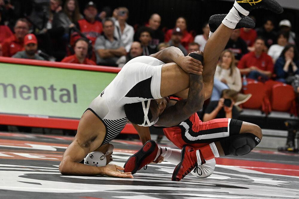 Redshirt freshman Vince Robinson slams opponent during the duel against Appalachian State in Reynolds Coliseum on Friday, Nov. 15, 2024. Robinson won the 125 bout 20-5. NC State beat App State 34-12.