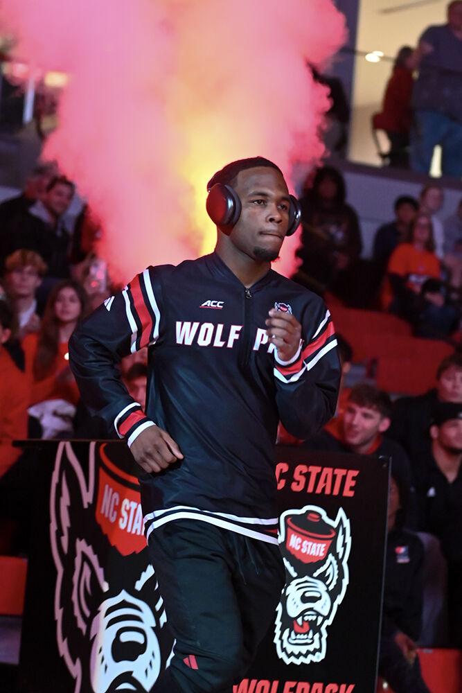 Redshirt freshman Vince Robinson makes an entrance before the duel against Appalachian State in Reynolds Coliseum on Friday, Nov. 15, 2024. Robinson won the 125 bout 20-5. NC State beat App State 34-12.