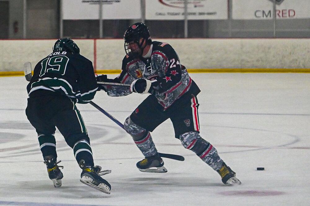 Freshman defender Jake Lipani blocks his opponent from reaching the puck during the game against Michigan State at the Invisalign Arena on Friday, Nov. 8, 2024.&#160;NC State beat Michigan State 4-2.