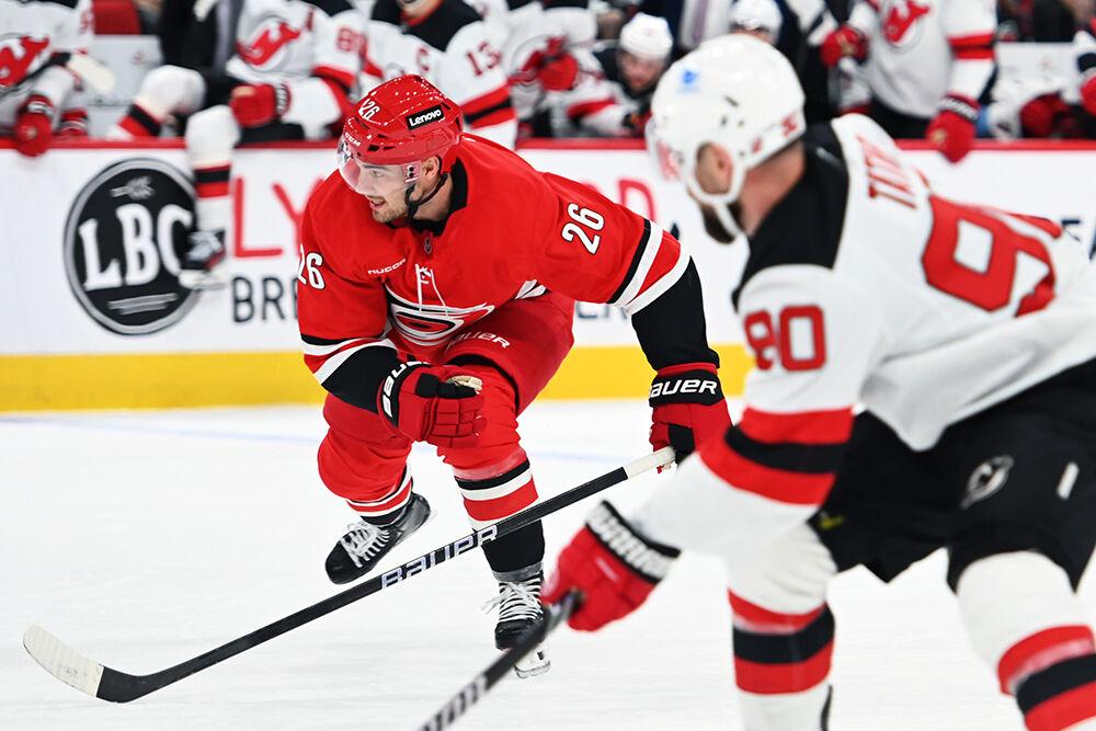 Defenseman Sean Walker races for the puck during the Hurricanes game against&#160;the New Jersey Devils at Lenovo Center on Tuesday, Oct. 15, 2024. The Hurricanes beat the Devils 4-2.
