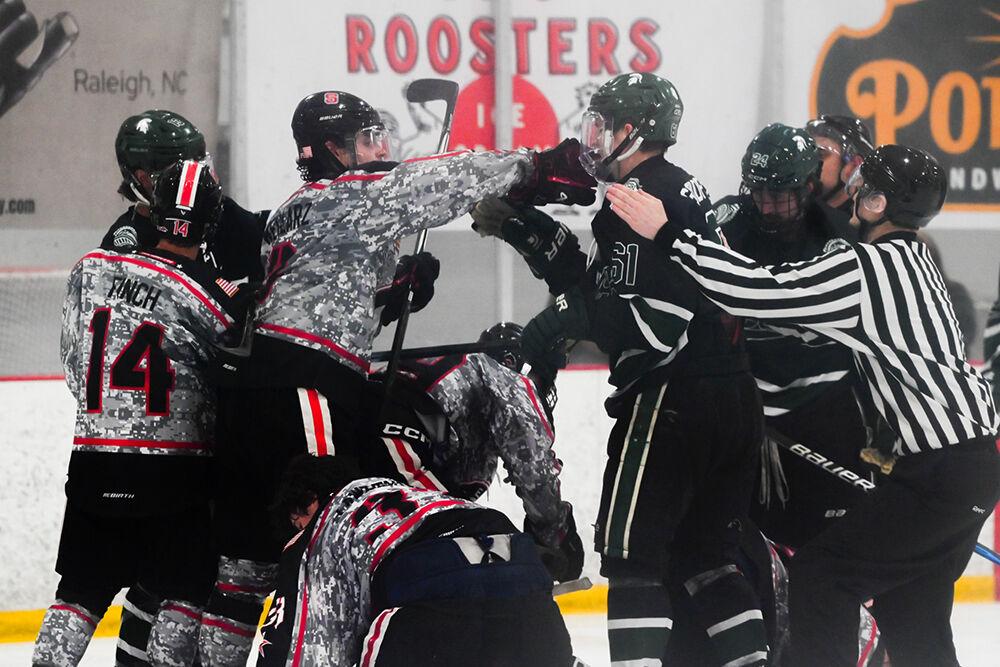 Freshman defender Jackson Weglarz punches a Michigan State opponent during the game against Michigan State at the Invisalign Arena on Friday, Nov. 8, 2024. NC State beat Michigan State 4-2.