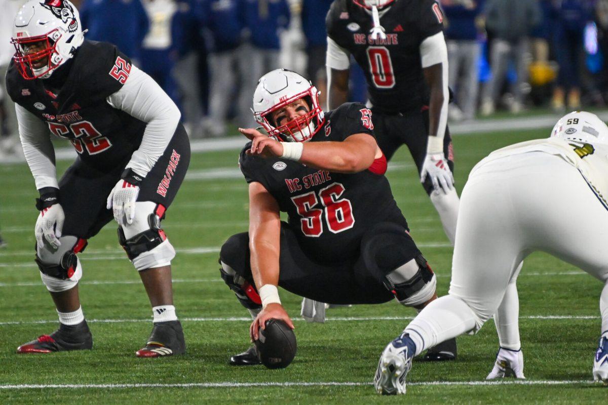 Graduate offensive lineman Zeke Correll talks to his teammates before the snap during the game against Georgia Tech in Bobby Dodd Stadium at Hundai Field in Atlanta on Thursday, Nov. 21, 2024. NC State lost to Georgia Tech 30-29.