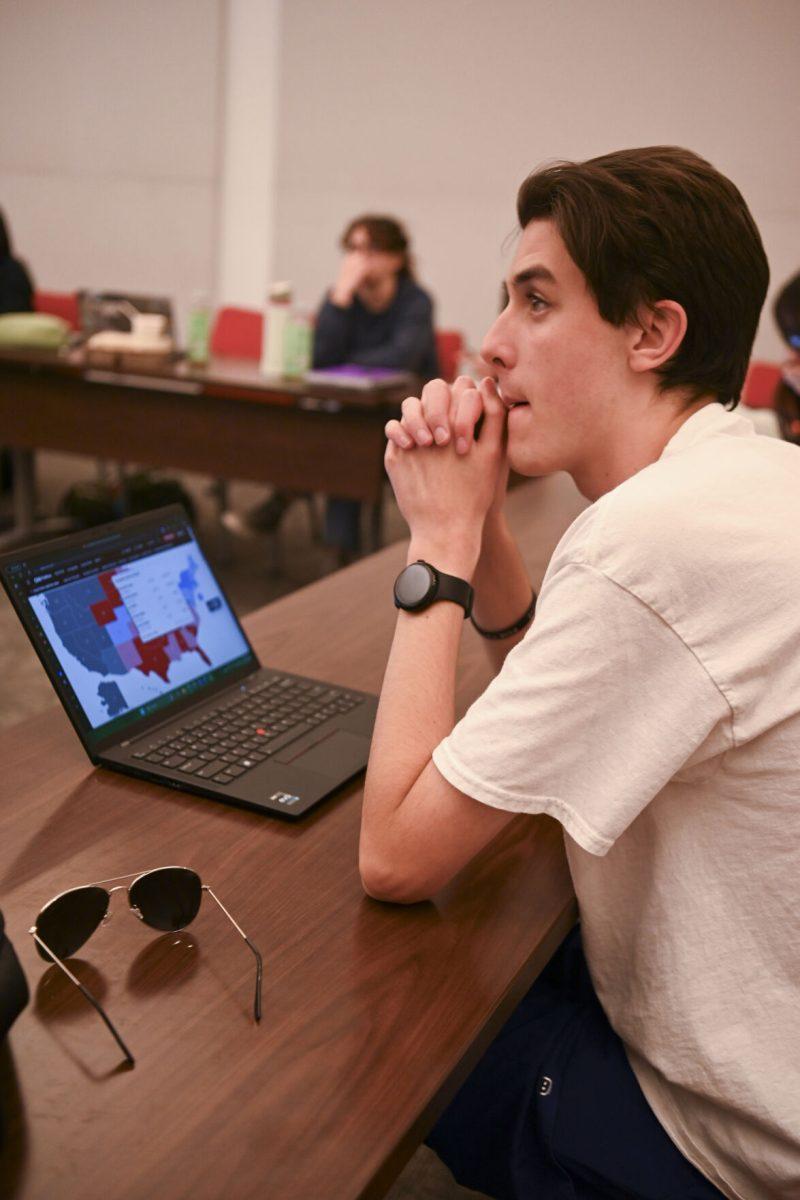 John Vanmeter-Kirk, a first-year studying psychology, watching the election results on his laptop at the NCSU Democrats election night watch party in Talley Student Union on Tuesday, Nov. 5, 2024. This event was hosted by NCSU democrats to discuss the election results as they unfolded.