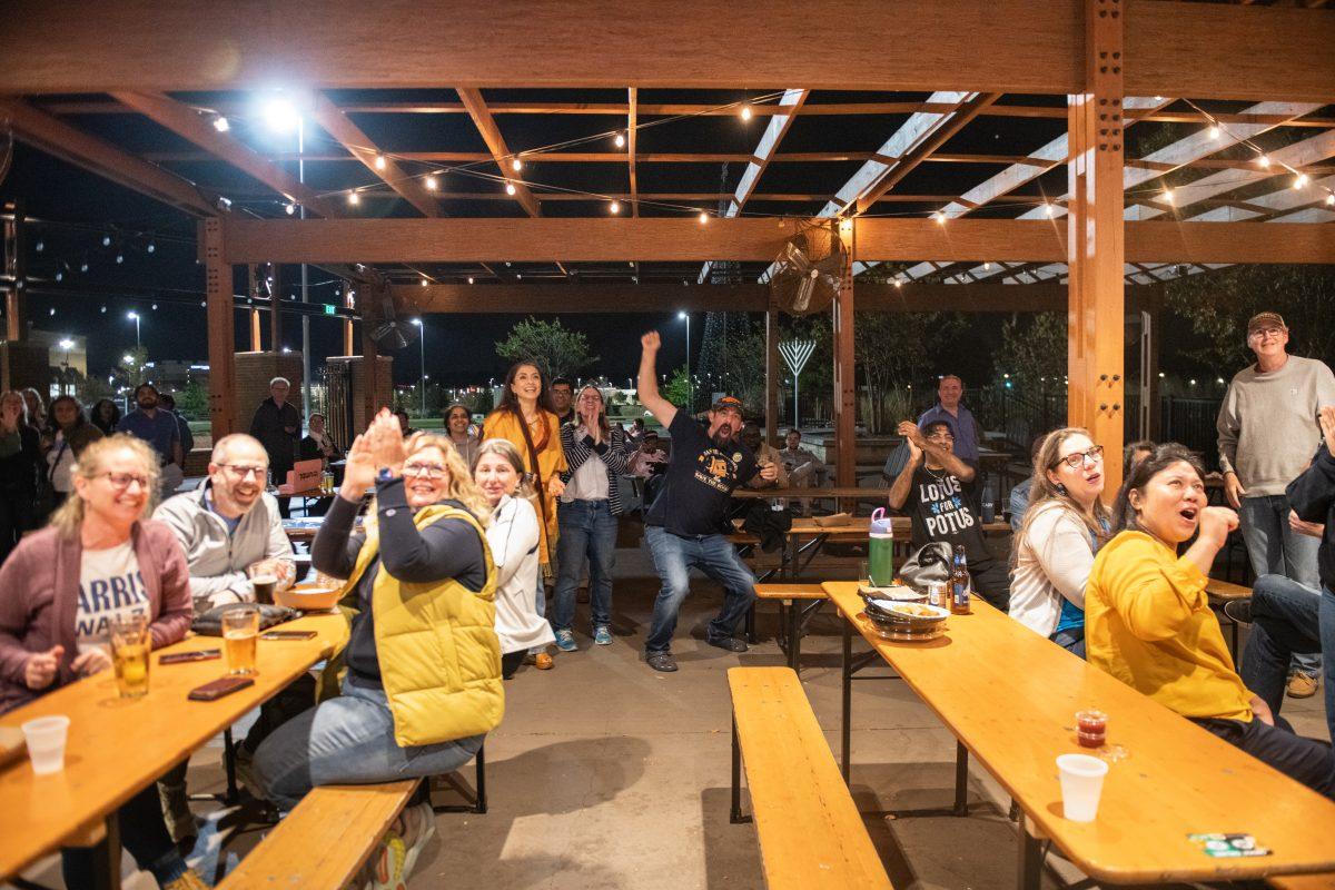 Crowd cheers as Kamala Harris announced victor of Colorado during the Wake County democrat watch party at Rosecomb Beer Garden on Tuesday Nov. 5, 2024. AP declared Trump the victor in the North Carolina Race.