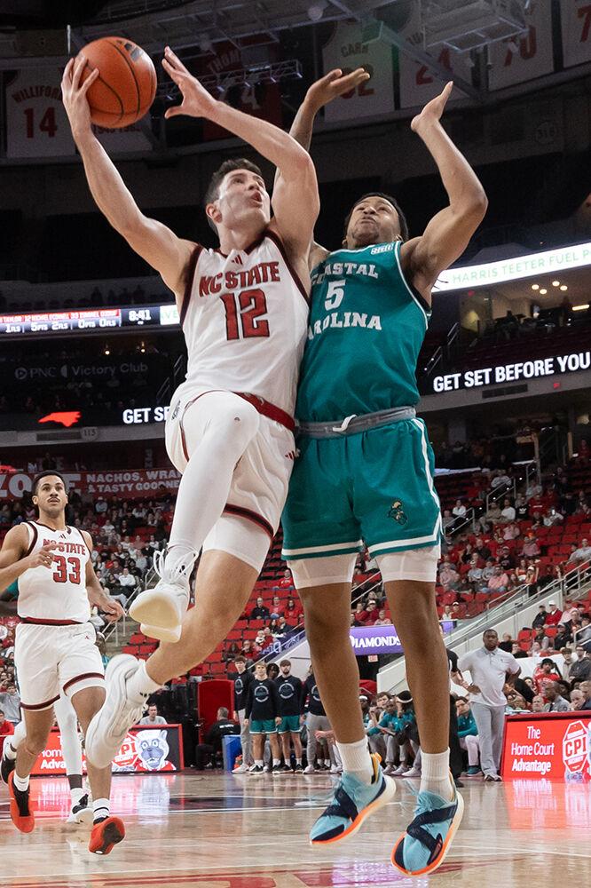 Graduate guard Michael O&#8217;Connell gets physical for a layup during the game against Coastal Carolina in the Lenovo Center on Wednesday, Nov. 13, 2024. O&#8217;Connell scored five points for the Wolfpack. NC State won the game 82-70.