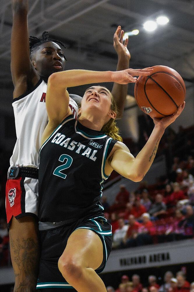 Senior guard Saniya Rivers jumps to prevent her opponent from scoring during the game against Coastal Carolina in Reynolds Coliseum on Thursday, Nov. 21, 2024. Rivers had a steal and a block. The Wolfpack beat the Chanticleers 89-68.