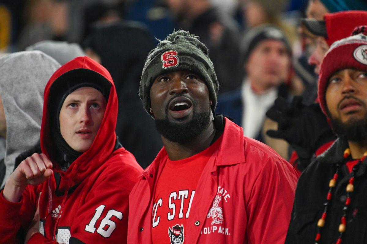 NC State fan Christopher Akpobiyeri watches a replay on the videoboard during the game against Georgia Tech in Bobby Dodd Stadium at Hundai Field in Atlanta on Thursday, Nov. 21, 2024. NC State lost to Georgia Tech 30-29.