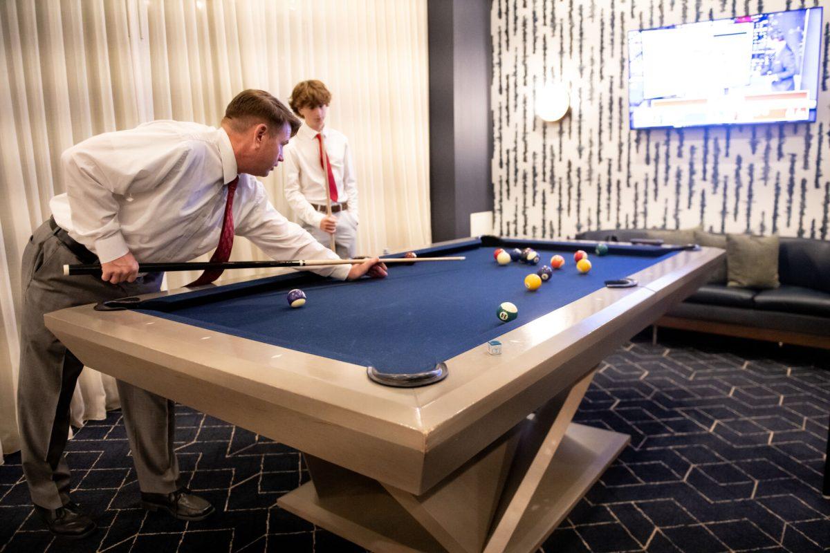 District judge 10D candidate Karl Roth plays pool with his kids at Wake County GOP watch party at Marriott Raleigh Cary Crossroads on Tuesday Nov. 5, 2024. The AP news declared Trump the Victor in North Carolina.