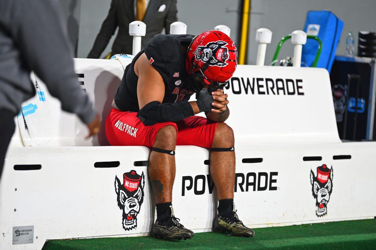 Senior defensive end Davin Vann holds his head after the football game against Duke at Carter-Finley Stadium on Saturday, Nov. 9, 2024. The Wolfpack lost to the Devils 29-19.