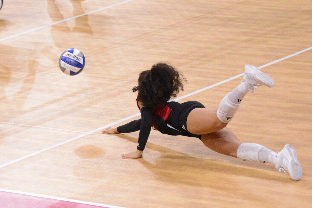 Junior defensive specialist/libero Syndey Daniels dives for the ball during the match against SMU at Reynolds Coliseum on Friday, Nov. 22, 2024. Daniels had one assist and eight digs. The Wolfpack lost to the Mustangs 3-2.