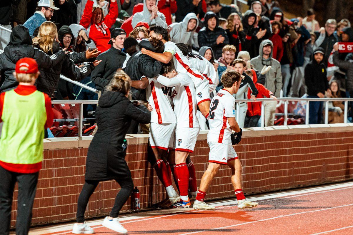 A group of NC State player celebrates with the crowd after taking the lead in regulation during the Wolfpack's first round home playoff game against the Charlottle 49ers at Dail Soccer Field on Thursday, Nov. 21, 2024. The Wolfpack beat the 49ers 2-1 in double overtime.