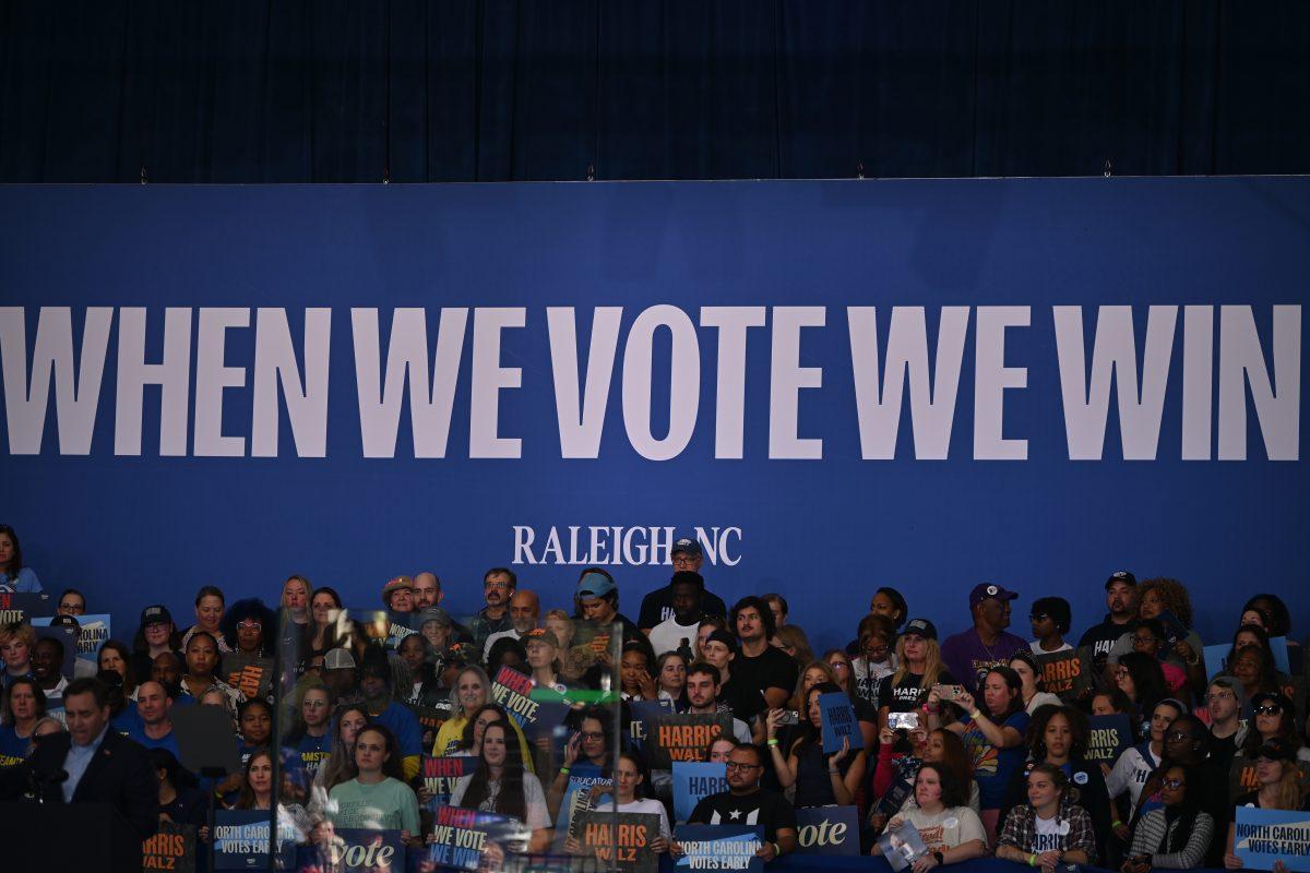 People line the stage under a "When We Vote We Win" banner at the the Kamala Harris campaign rally at Coastal Credit Union Music Park at Walnut Creek on Wednesday, Oct. 31, 2024. The event that was head lined by the Vice President also included Attorney General Josh Stein and Governor Roy Cooper among other prominent North Carolina Democrats.