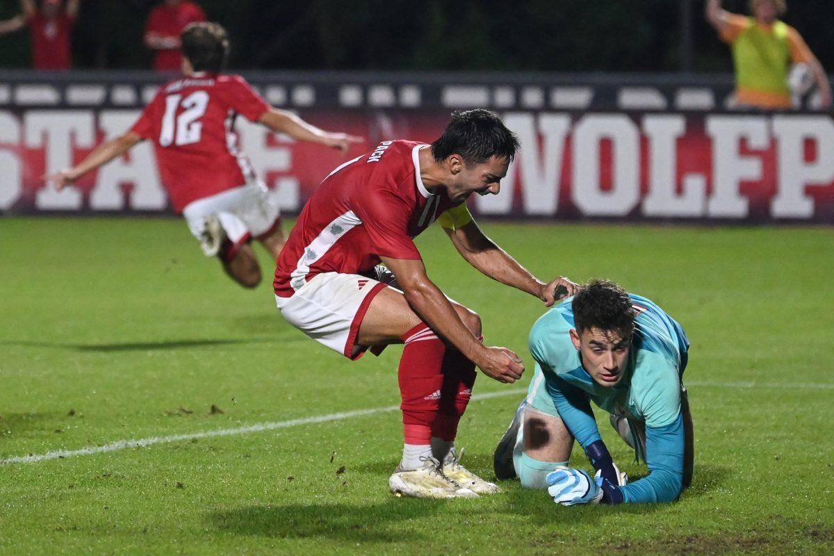 Senior midfielder/forward Henrique Santos celebrates junior center attacking midfielder Taig Healy's goal in front of the Virginia goalkeeper during NC State's home ACC playoff game against Virginia at Dail Soccer Field on Wednesday, Nov. 6, 2024. The Cavaliers came from behind to defeat the Wolfpack 2-1 despite a flury of shot attempts from the Wolfpack within the last minute of the game.