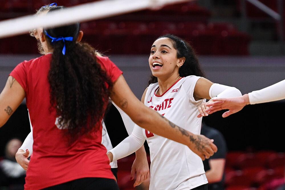 Junior libero Sydney Daniels high-fives her teammates during the match against Wake Forest in Reynolds Coliseum on Wednesday, Nov. 13, 2024. NC State won all three sets against Wake Forest.
