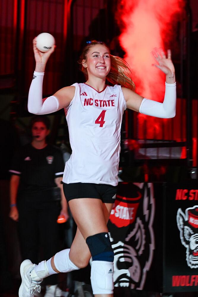 Junior middle blocker Sophie Groom throws a souvenir into the crowd before the match against Wake Forest in Reynolds Coliseum on Wednesday, Nov. 13, 2024. Groom earned 5 points during the match. NC State beat Wake Forest 3-0.