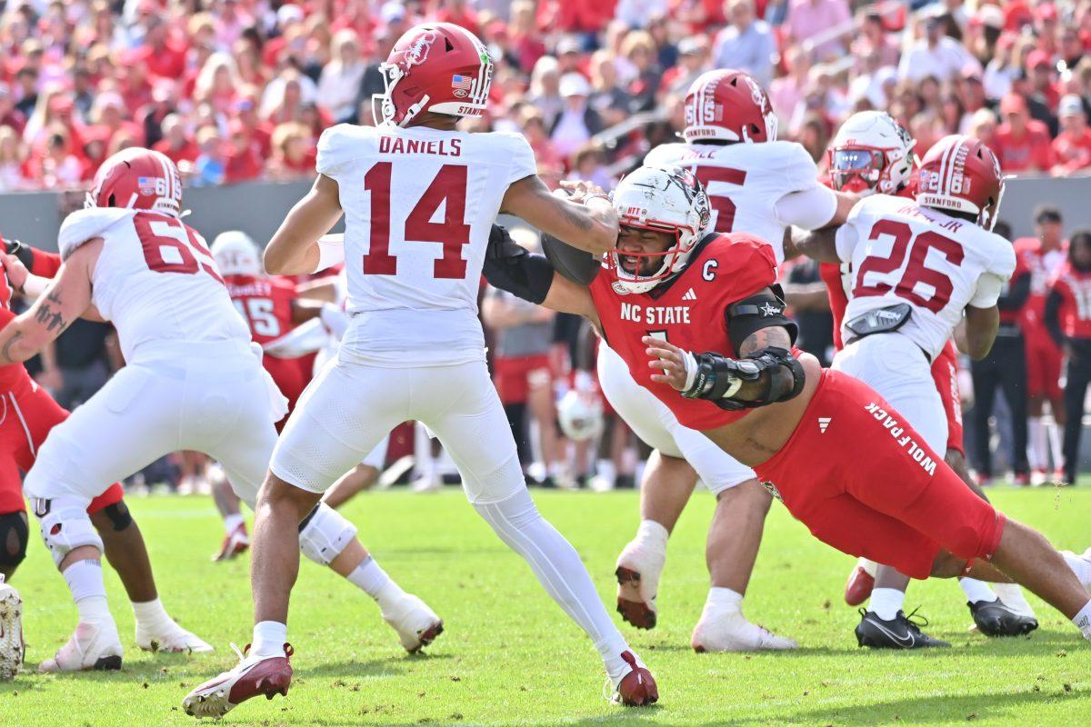 Graduate defensive end Davin Vann performs a strip sack on the Stanford quarterback, Ashton Daniels, during NC State's game against Stanford in Carter-Finley Stadium on Saturday, Nov. 2, 2024. The Wolfpack beat the Cardinal 59-28.