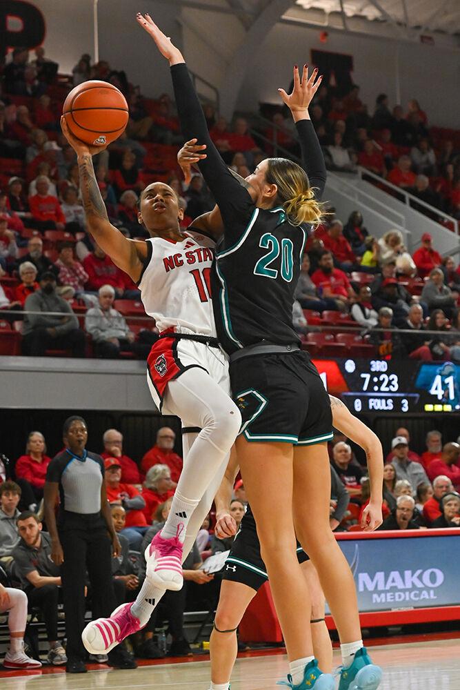 Senior guard Aziaha James goes for a bank shot during the game against Coastal Carolina in Reynolds Coliseum on Thursday, Nov. 21, 2024. NC State beat Coastal Carolina 89-68.