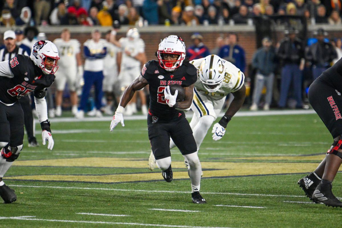 Redshirt freshman running back Hollywood Smothers rushes upfield during the game against Georgia Tech in Bobby Dodd Stadium at Hundai Field in Atlanta on Thursday, Nov. 21, 2024. Smothers rushed for 79 yards and one touchdown. NC State lost to Georgia Tech 30-29.