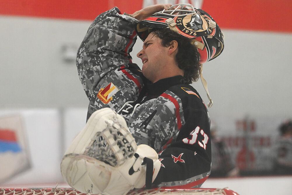 Senior goalie Addison Lawrence takes off his face shield after the final period during the game against Michigan State at the Invisalign Arena on Friday, Nov. 8, 2024. NC State beat Michigan State 4-2.