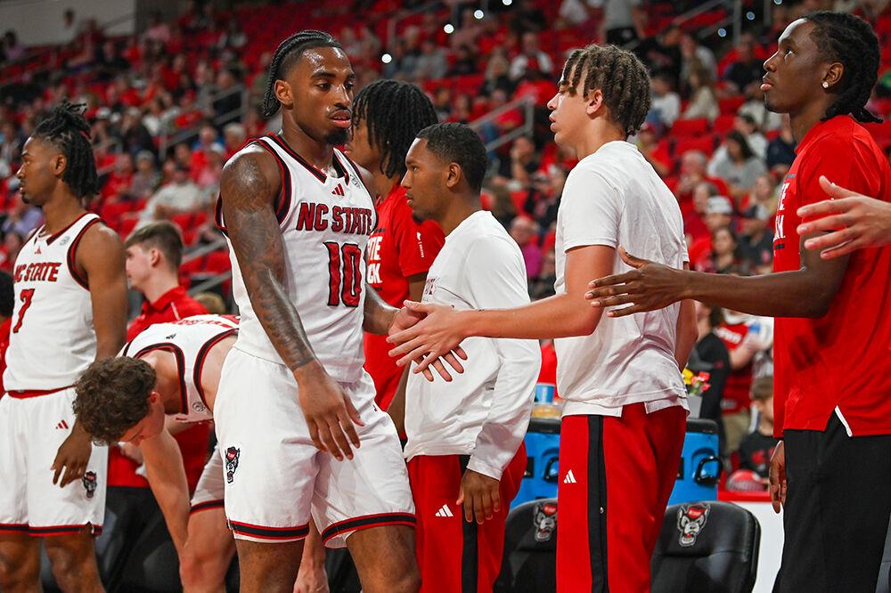 Senior guard Marcus Hill high-fives teammates on the NC State's mens baketball team during the game against Presbyterian in the Lenovo Center on Friday, Nov. 8, 2024. Hill had three rebounds and scored seven points. NC State beat Presbyterian 81-72.
