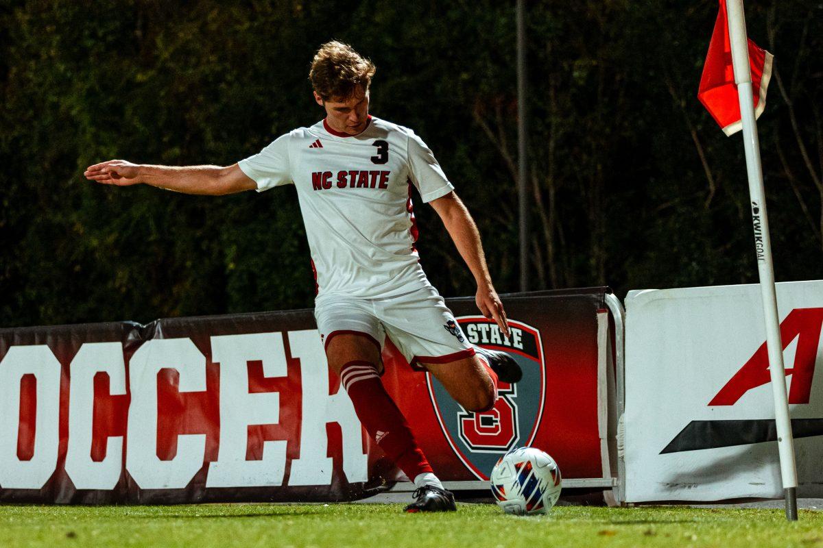 Graduate defender Liam Bennett takes a corner kick to set up a potential shot on goal for his teammates during the Wolfpack's first round home playoff game against the Charlottle 49ers at Dail Soccer Field on Thursday, Nov. 21, 2024. The Wolfpack beat the 49ers 2-1 in double overtime.