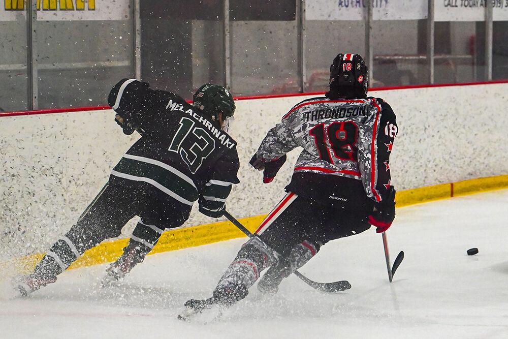 Sophomore defender Andrew Throndson rushes for the puck during the game against Michigan State at the Invisalign Arena on Friday, Nov. 8, 2024. NC State beat Michigan State 4-2.