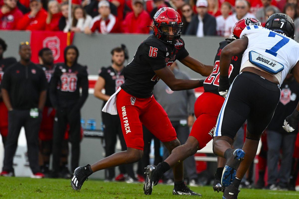 Freshman quarterback CJ Bailey hands the ball off during the football game against Duke at Carter-Finley Stadium on Saturday, Nov. 9, 2024. The Wolfpack lost to the Blue Devils 29-19. Bailey threw for 184 yards and recorded one passing touchdown.