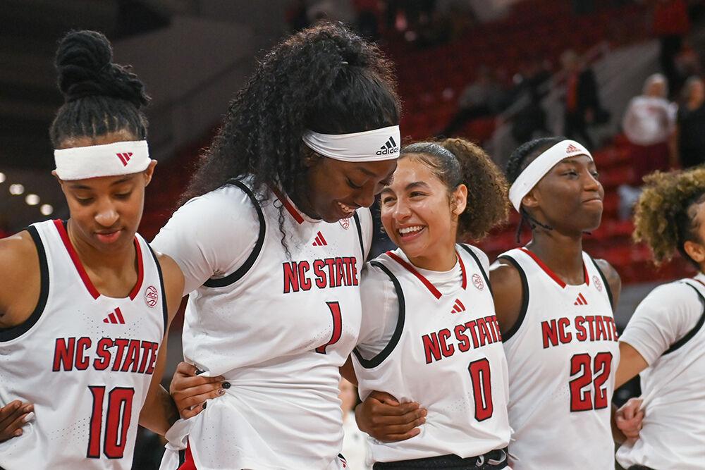 Freshman center Lorena Awou (left) and freshman guard Devyn Quigley (right) laugh together after the game against Kent State in Reynolds Coliseum on Thursday, Nov. 14, 2024. NC State won the game 79-51.