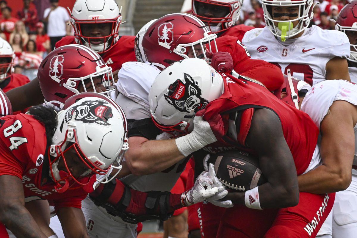 Graduate running back Jordan Waters pushes through the defense with the ball during the game against Stanford at Carter-Finley Stadium on Saturday, Nov. 2, 2024. Waters ran 115 yards during the game. NC State beat Stanford 59-28.
