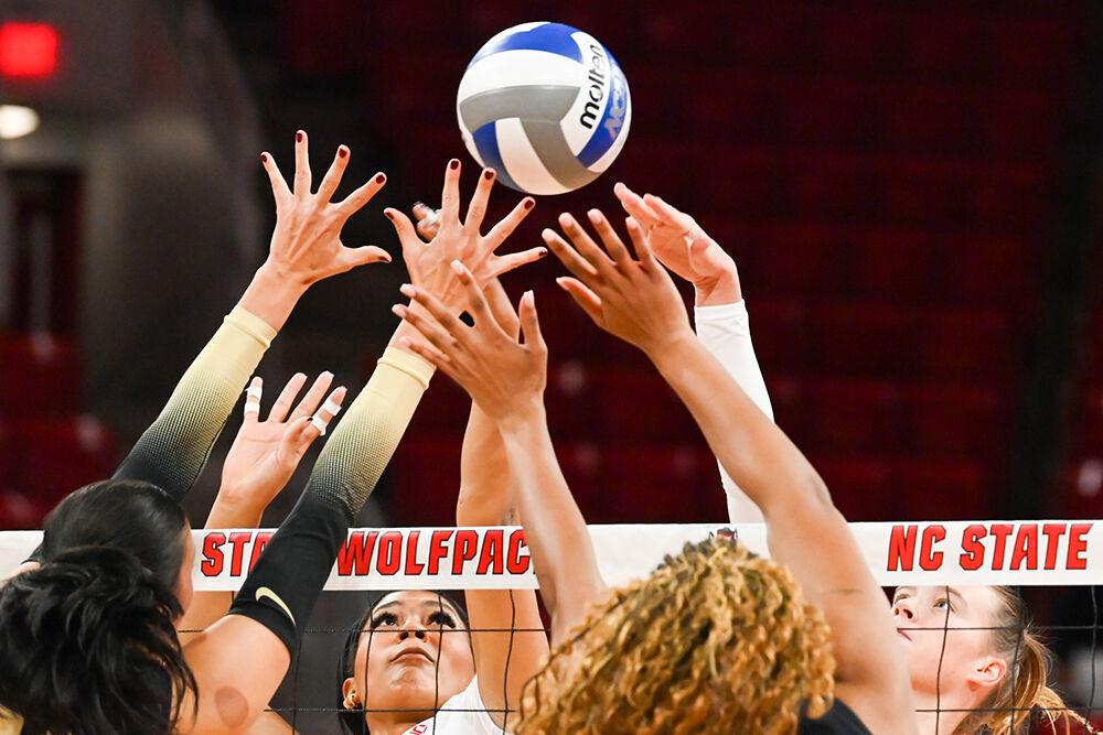Senior middle blocker Jada Allen and junior outside hitter Courtney Bryant fight to tip the ball during the match against Wake Forest in Reynolds Coliseum on Wednesday, Nov. 13, 2024. Allen and Bryant combined for a total of 18 points earned during the match. NC State beat Wake Forest 3-0.