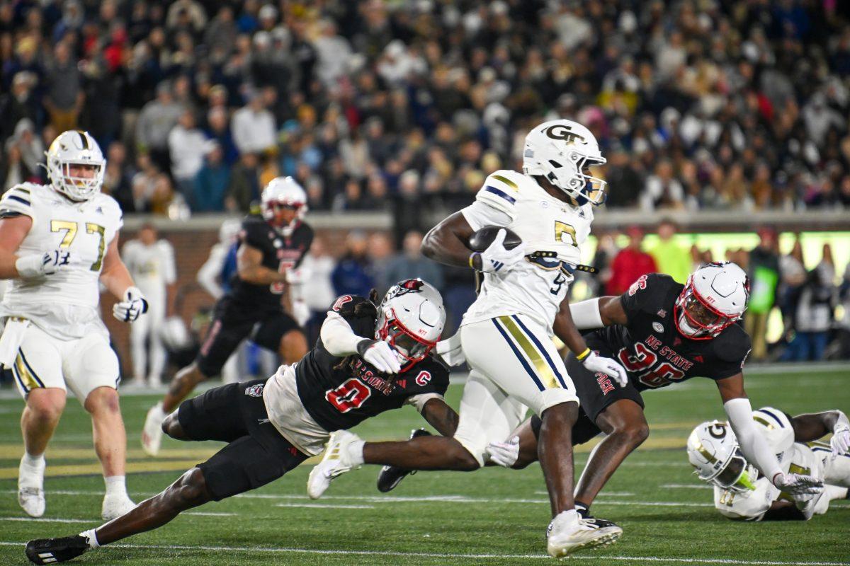 Redshirt junior linebacker Sean Brown dives to tackle the ball carrier during the game against Georgia Tech in Bobby Dodd Stadium at Hundai Field in Atlanta on Thursday, Nov. 21, 2024. Brown had six tackles. NC State lost to Georgia Tech 30-29.