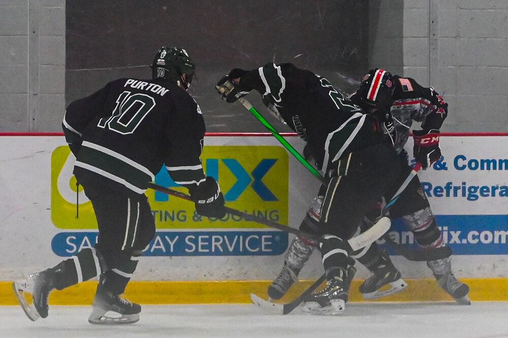 Senior forward Emery Oliver fights for possession of the puck during the game against Michigan State at the Invisalign Arena on Friday, Nov. 8, 2024. NC State beat Michigan State 4-2.