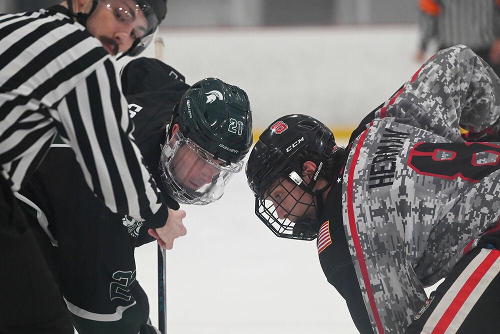 Junior forward Zachary Herman engages in a face-off with a Michigan State opponent during the game against Michigan State at the Invisalign Arena on Friday, Nov. 8, 2024. NC State beat Michigan State 4-2.