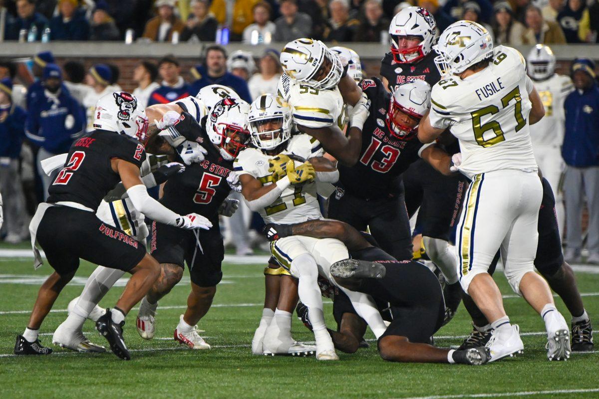 The NC State defense attempts to stop a rushing attempt during the game against Georgia Tech in Bobby Dodd Stadium at Hundai Field in Atlanta on Thursday, Nov. 21, 2024. NC State lost to Georgia Tech 30-29.