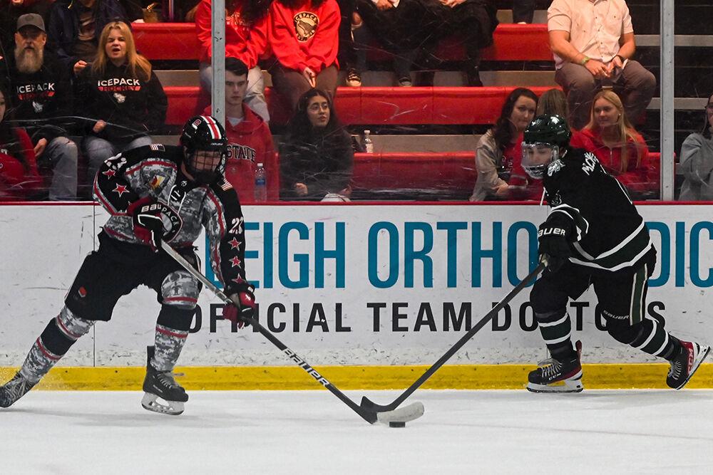 Freshman forward Brooks Willoughby-Ray reaches for the puck during the game against Michigan State at the Invisalign Arena on Friday, Nov. 8, 2024. NC State beat Michigan State 4-2.
