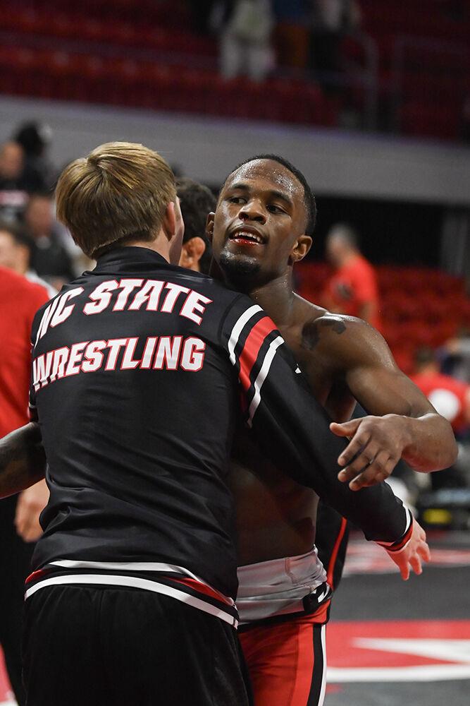 Redshirt freshman Vince Robinson hugs teammate after the duel against Appalachian State in Reynolds Coliseum on Friday, Nov. 15, 2024. Robinson won the 125 bout 20-5. NC State beat App State 34-12.