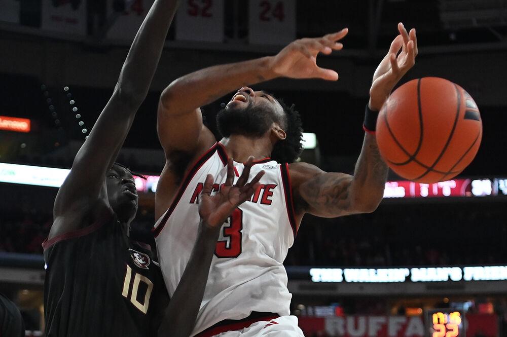 Senior guard Dontrez Styles is fouled during the game against Florida State in the Lenovo Center on Saturday, Dec. 7, 2024. Styles scored 21 points and made five rebounds. NC State won the game 84-74.