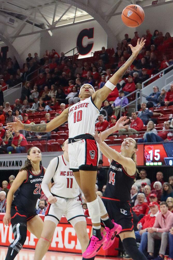 Senior guard Aziaha James jumps for the ball during the game against Davidson College on Wednesday, Dec. 11, 2024. James scored 21 points and caught eight rebounds. NC State beat Davidson College 59-57.