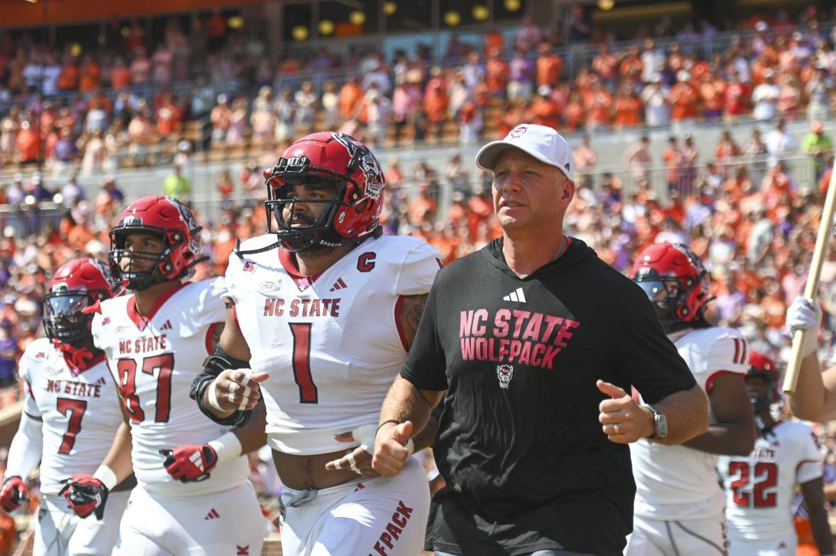 NC State football head coach Dave Doeren runs onto the field with the football team during the football game against Clemson in Memorial Stadium on Saturday, Sept. 21, 2024.&#160;Clemson beat NC State 59-35.