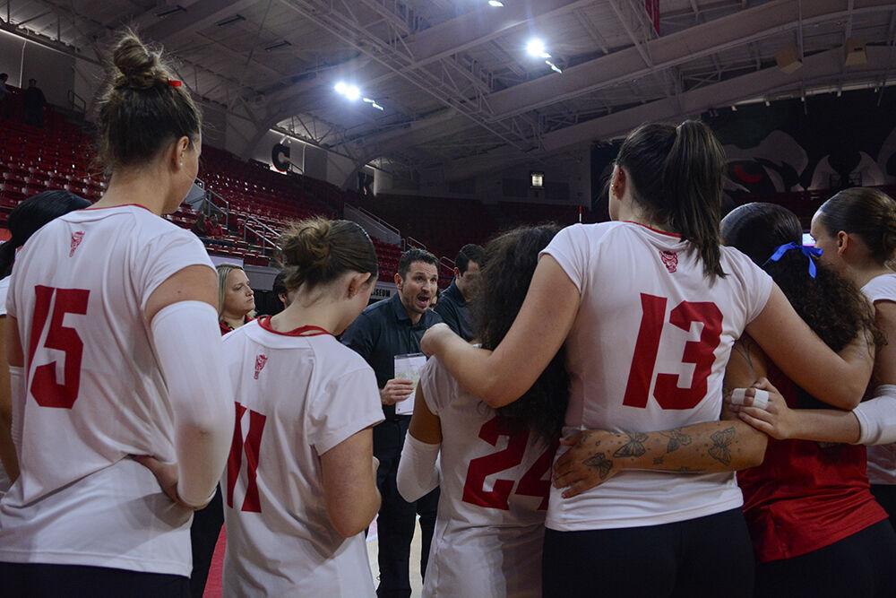 Head coach Luka Slabe huddles with the team after winning the match against Wake Forest in Reynolds Coliseum on Wednesday, Nov. 13, 2024. The Wolfpack defeated the Demon Deacons 3-0.