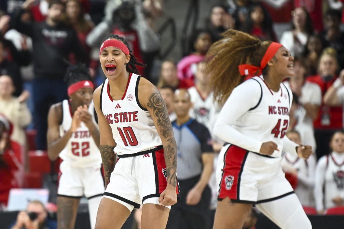 Senior guard Aziaha James celebrates a call in the Wolfpack's favor during the women's basketball game against Ole Miss in Reynolds Coliseum on Thursday, Dec. 5, 2024. James scored 11 points and had four steals. NC State beat Ole Miss 68-61.