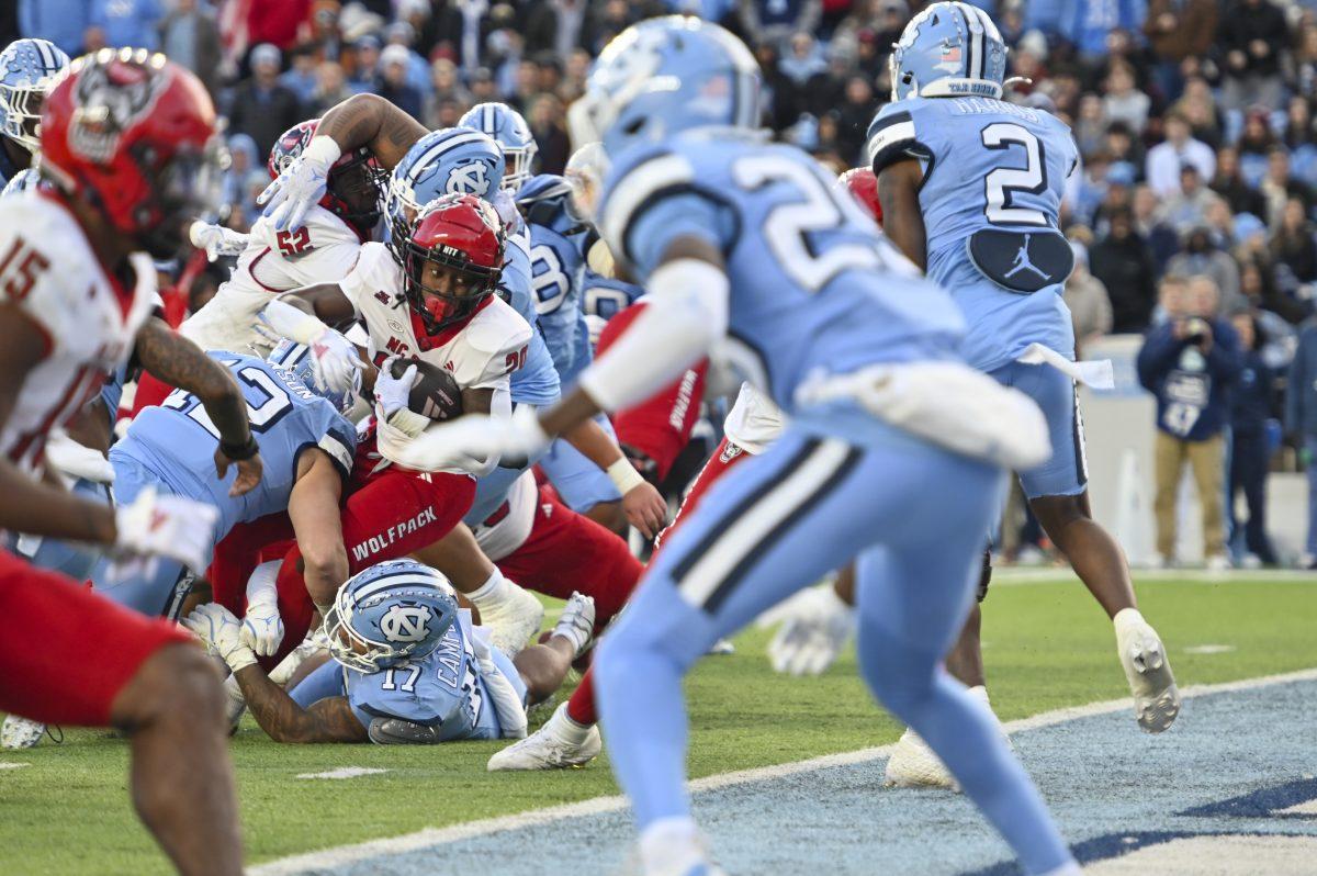Redshirt freshman running back Hollywood Smothers tries to land in the endzone during the football game against UNC-Chapel Hill at Kenan Stadium on Saturday, Nov. 30, 2024. Hollywood scored two touchdowns and rushed for 83 net yards. NC State beat UNC 35-30.