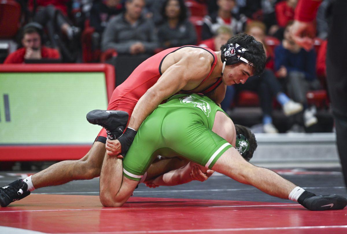 Redshirt sophomore Matty Singleton restrains his opponent's leg during the wrestling match against Utah Valley in Reynolds Coliseum on Saturday, Nov. 23, 2024. Singleton won his duel 11-6. NC State beat Utah Valley 23-16.